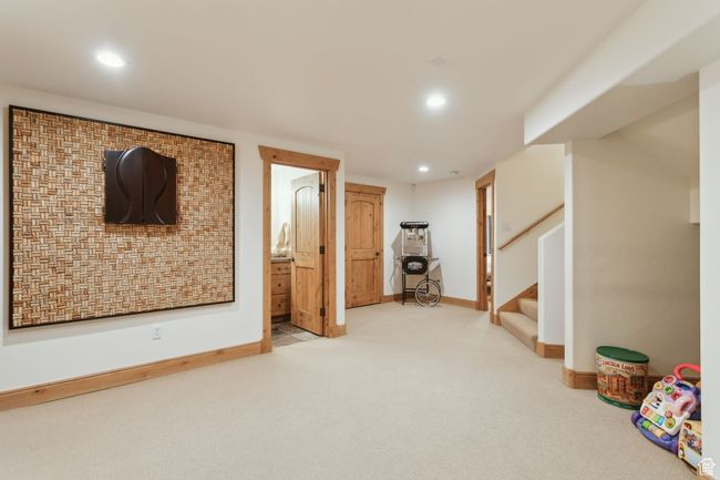 Finished below grade area featuring carpet flooring, recessed lighting, baseboards, and stairs | Image 47