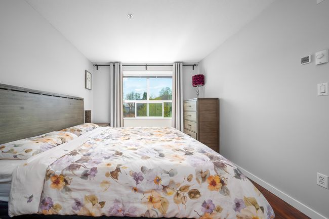 Bedroom with dark wood-type flooring and baseboards | Image 15