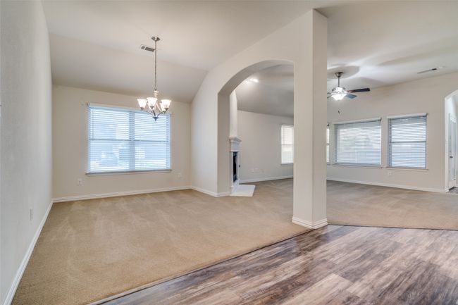 Dining room and living room featuring a ceiling fan, carpet, healthy amount of natural light, arched walkways, and vaulted ceiling | Image 5
