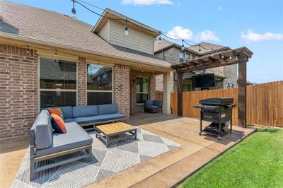 View of patio featuring a pergola, an outdoor living space, and area for grilling | Image 2