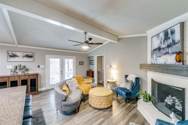 Another view of the den and the double doors lead out to the covered patio and the pool | Image 7