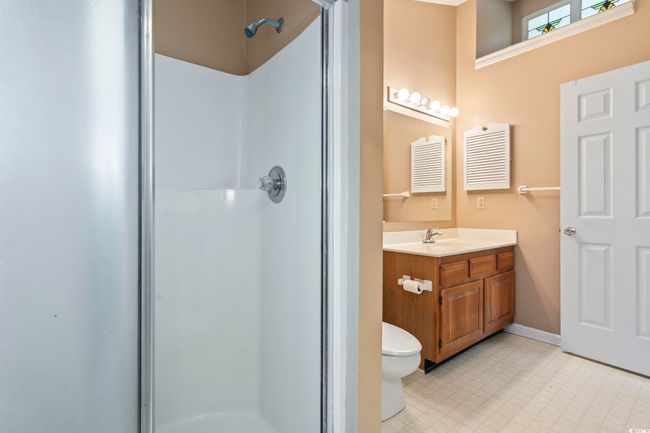 Full bathroom featuring a stall shower, vanity, toilet, and baseboards | Image 21