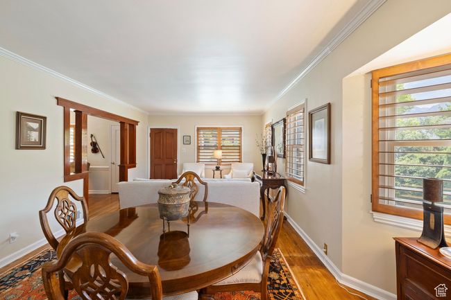 Dining room featuring light wood-type flooring, healthy amount of natural light, and ornamental molding | Image 7