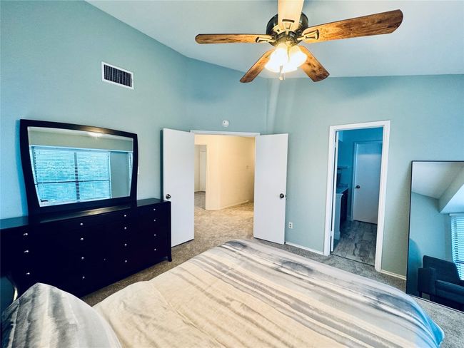 Bedroom featuring carpet floors, a ceiling fan, and high vaulted ceiling | Image 18
