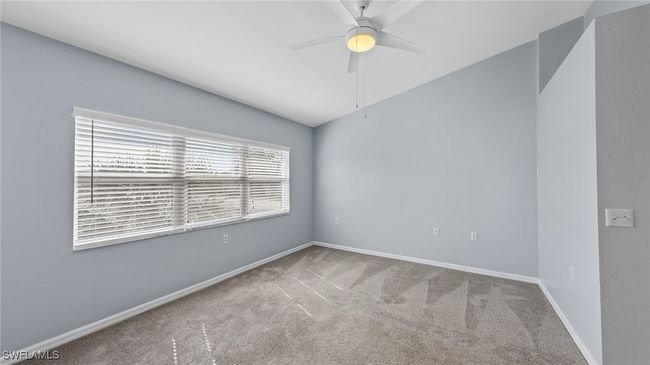 Carpeted spare room with ceiling fan and baseboards | Image 12