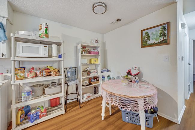 Unit A Game room featuring a textured ceiling and hardwood / wood-style flooring | Image 33