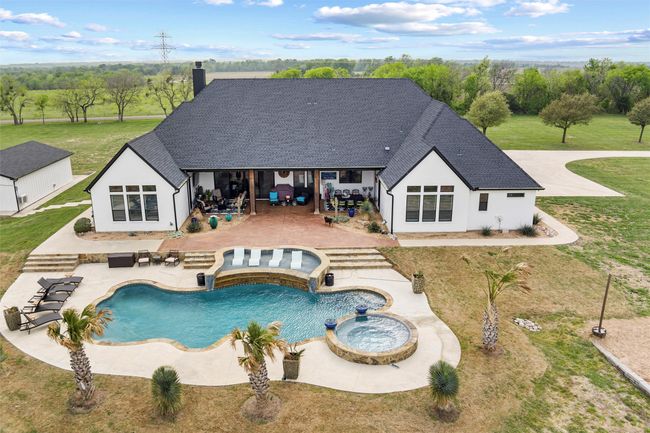 View of pool featuring a pool with connected hot tub, a lawn, and a patio | Image 34
