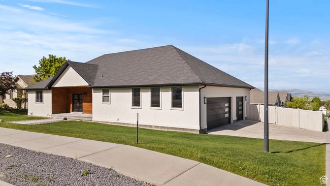 View of front of house with driveway, an attached garage, a shingled roof, and stucco siding | Image 42
