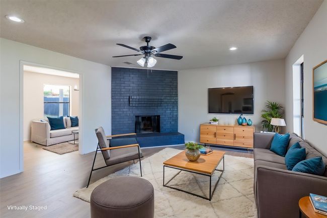 Living room with a fireplace, wood finished floors, recessed lighting, and ceiling fan | Image 22