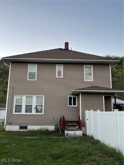 Rear view of house with a lawn | Image 3