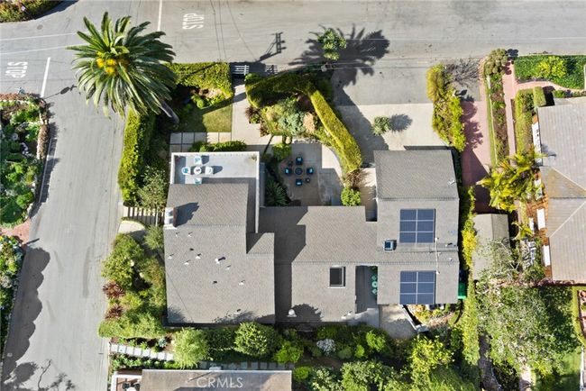 Mature privacy hedges create a secret sanctuary for indoor/outdoor living on a large corner homesite that spans approximately 7, 500 square feet. | Image 24