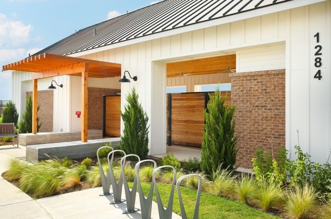 Entrance to property with a standing seam roof, brick siding, and metal roof | Image 6