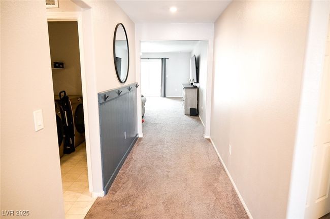 Corridor featuring baseboards and light carpet | Image 6