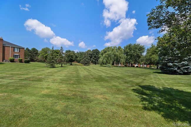View of community with a yard and view of scattered trees | Image 16