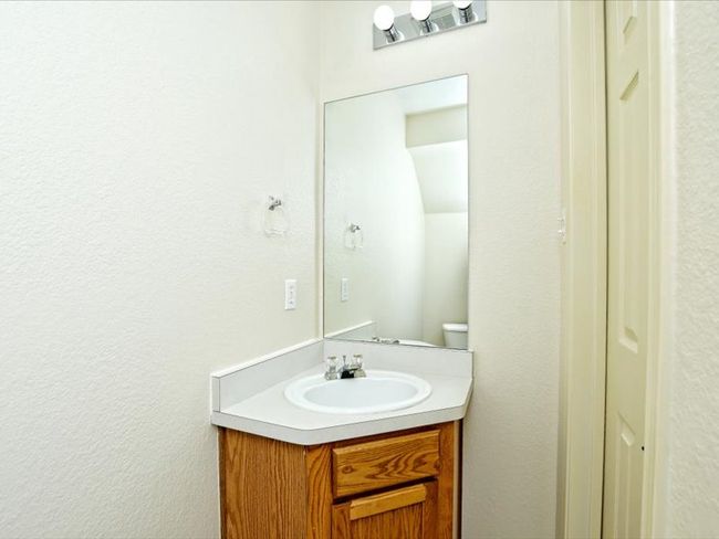 Bathroom featuring a textured wall and vanity | Image 24
