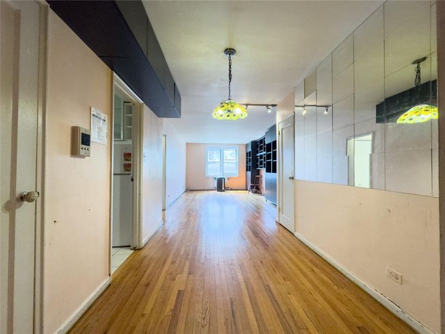Corridor featuring light wood finished floors and baseboards | Image 6
