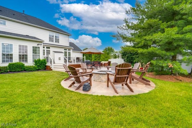 View of grassy yard with a gas fire pit and a patio area | Image 40