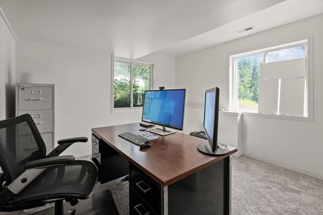 Home office featuring healthy amount of natural light and carpet | Image 39