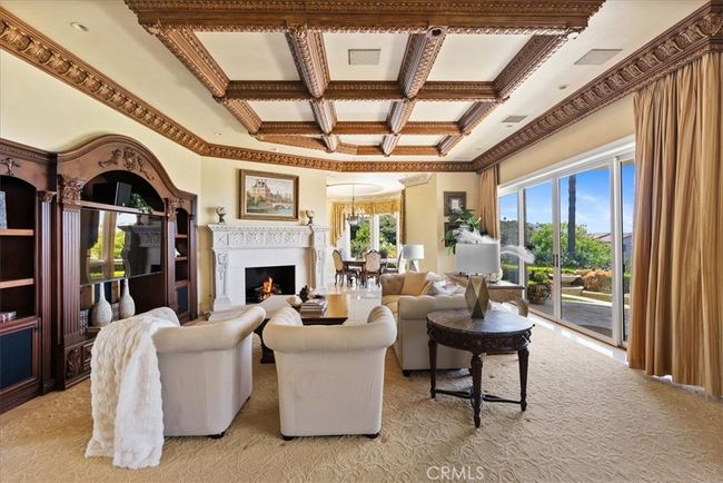 Large Family Room with cozy fireplace, built-in entertainment center, oversized sliding doors that lead to your patio, pool and OCEAN VIEWS! | Image 10