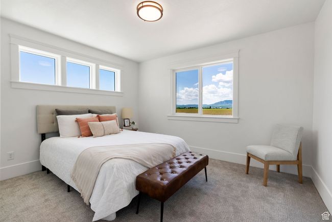 Bedroom featuring light carpet and baseboards | Image 13