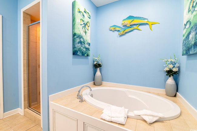Full bath featuring a shower stall, a bath, and tile patterned floors | Image 32