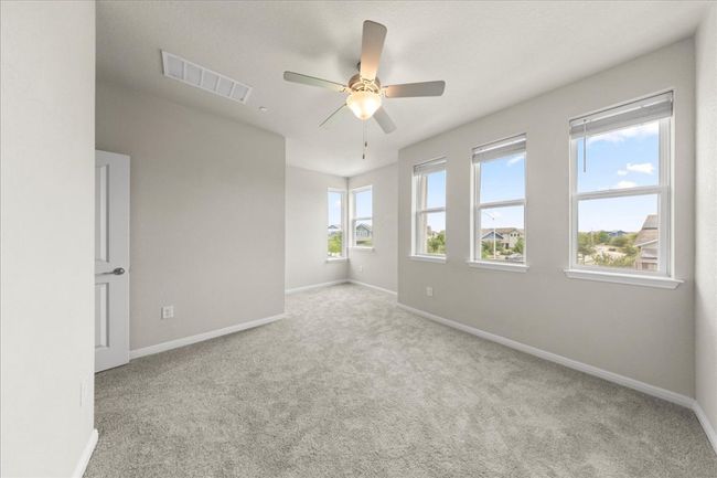 Unfurnished room featuring carpet flooring, baseboards, and ceiling fan | Image 18