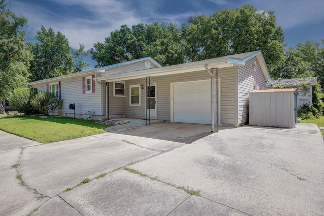 Single story home with a garage, concrete driveway, and a front lawn | Image 21