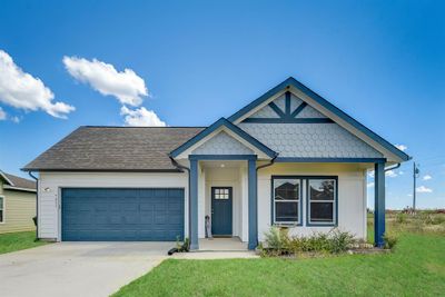 View of front of property with a garage and a front lawn | Image 1