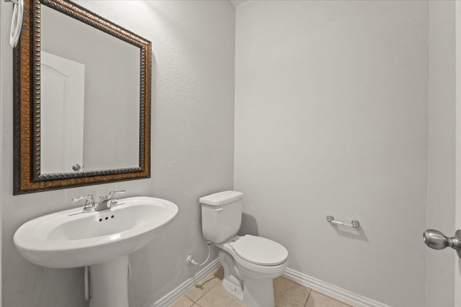 A half bath for guests is just off the living room | Image 5