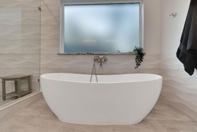 Designed for indulgence, this soaking tub offers a tranquil escape within the beautifully appointed primary suite. | Image 28