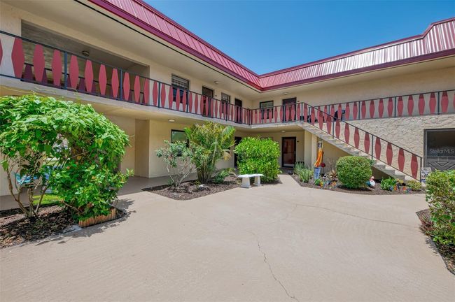 Bright, tropical courtyard, lush garden to relaxing. | Image 4