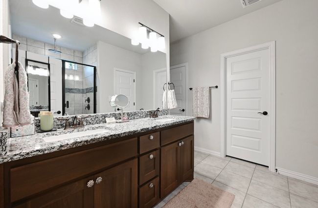 Master Bathroom featuring a shower stall, double vanity, and tile patterned flooring | Image 15