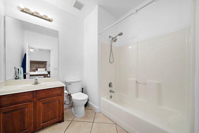 Simple bathroom with a shower-tub combination. | Image 29
