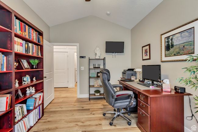 Office space featuring light wood finished floors and vaulted ceiling | Image 22