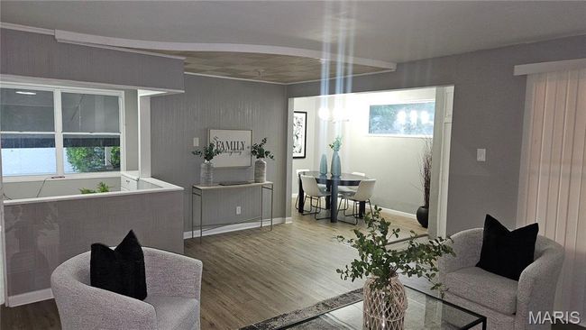 Living area featuring wood finished floors and baseboards | Image 5
