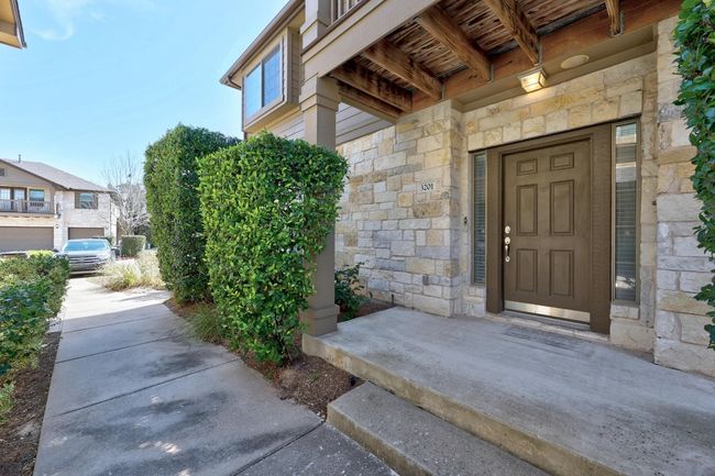View of exterior entry featuring stone siding | Image 4