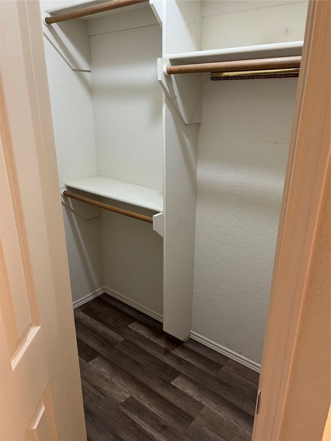 Spacious closet featuring dark wood finished floors | Image 33