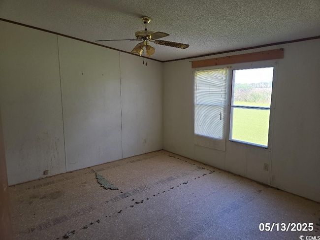 Unfurnished room with ceiling fan and a textured ceiling | Image 19