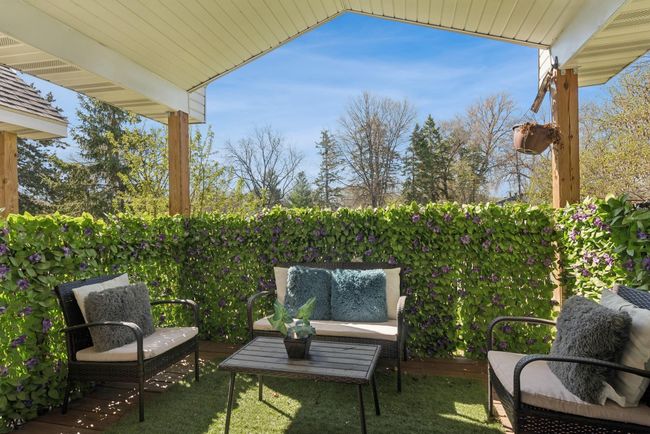 This is a view of the covered deck. Again, lower maintenace all around... look at the ceiling! The current owner added artifical hedging to provide additional privacy and to create a peaceful and relaxing outdoor space. | Image 10