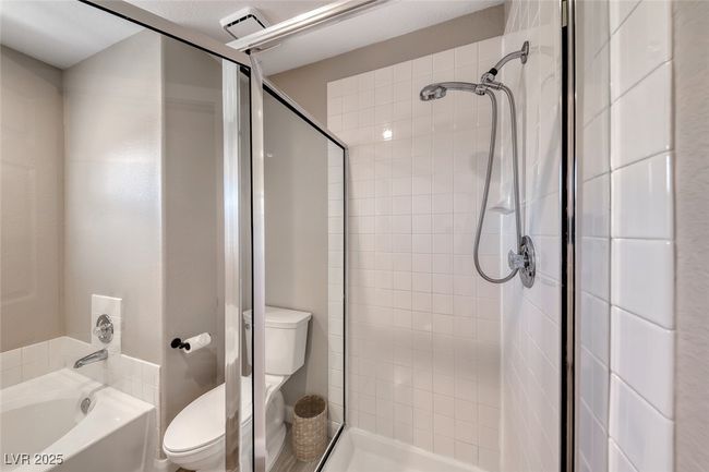 Full bathroom with a stall shower and a tub | Image 22