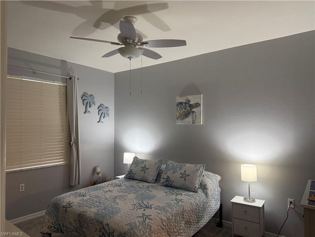 Bedroom featuring baseboards, a ceiling fan, and carpet | Image 11