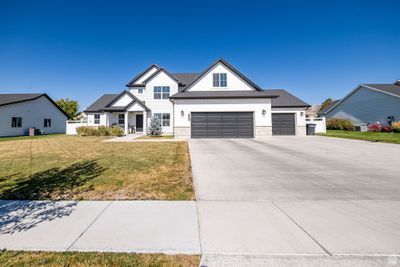 View of front facade featuring a front lawn and a garage | Image 2