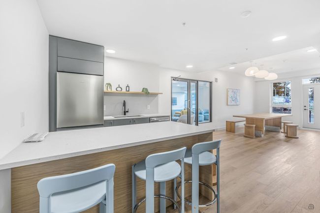 Kitchen with gray cabinetry, a breakfast bar, recessed lighting, light wood-style floors, and a sink | Image 24