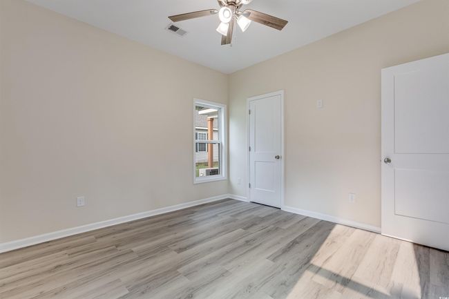 Unfurnished bedroom featuring light wood-style flooring, baseboards, and ceiling fan | Image 22