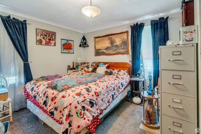 Bedroom with carpet floors and crown molding | Image 6