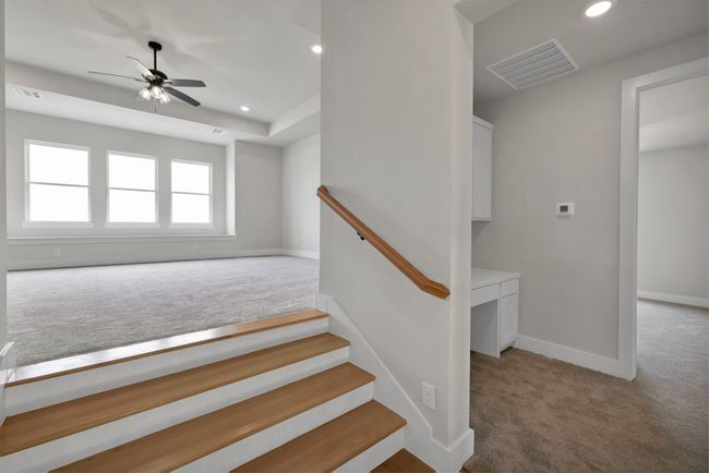 Staircase featuring carpet floors, recessed lighting, a ceiling fan, and a raised ceiling | Image 21