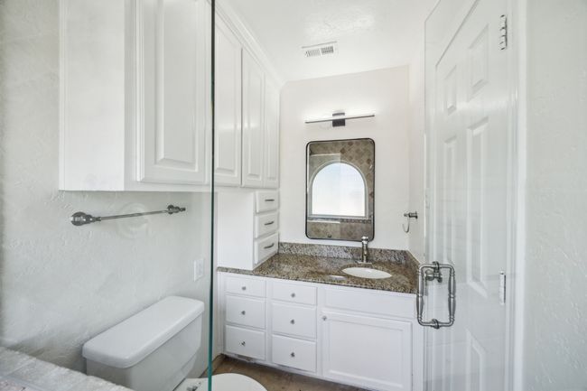 Bathroom featuring toilet , vanity, ample storage and walk in shower | Image 19