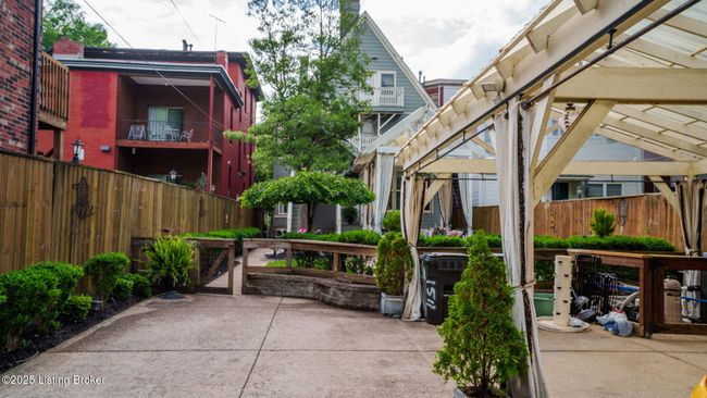 3-car carport at rear of yard with electronic gate entering from the alley. | Image 43