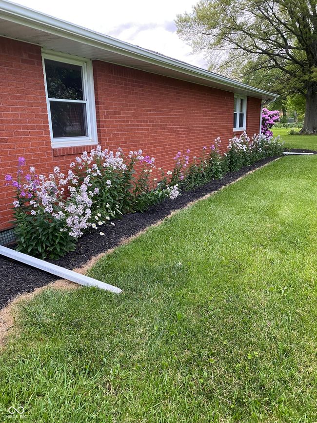 view of side of property featuring brick siding and a yard | Image 43