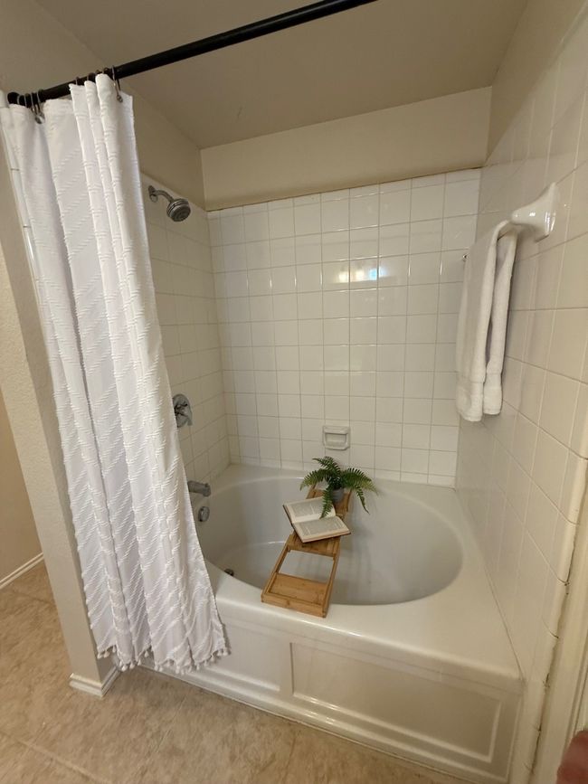 Full bathroom featuring tile patterned floors and shower / tub combo | Image 18